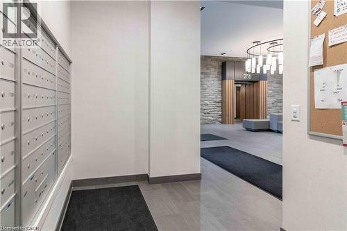 Mailroom with individual lockable mailboxes, contemporary tile flooring, and integrated baseboards - 251 Northfield Drive E Unit# 406, Waterloo, ON - Indoor Photo Showing Other Room