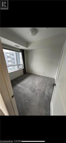 Room featuring neutral wall tones and grey carpet flooring - 251 Northfield Drive E Unit# 406, Waterloo, ON - Indoor