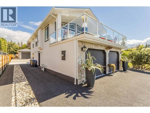 New rubber driveway, with access to the back yard through the gate - 4325 Takla Road, Kelowna, BC 