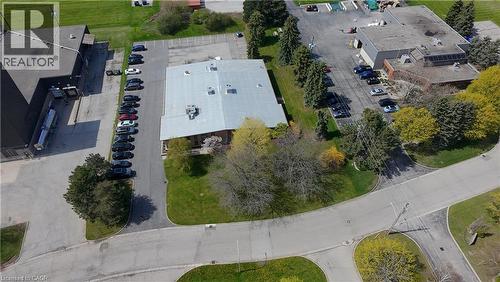 Commercial property featuring two buildings, expansive parking, paved access roads, and perimeter landscaping - 920 Sheldon Court, Burlington, ON 