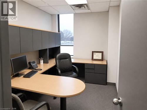 Dedicated workspace featuring an L-shaped desk with a light wood-finish surface and dark grey cabinetry - 920 Sheldon Court, Burlington, ON 