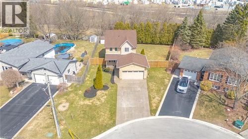 Two-story residence featuring a brown shingle roof, attached garage, concrete driveway, and front lawn with mature landscaping - 200 Morrison Drive, Caledonia, ON - Outdoor