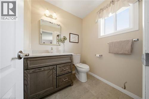 Bathroom featuring a single vanity with a gray wood-finish cabinet, a rectangular undermount sink, and a light-toned countertop - 200 Morrison Drive, Caledonia, ON - Indoor Photo Showing Bathroom