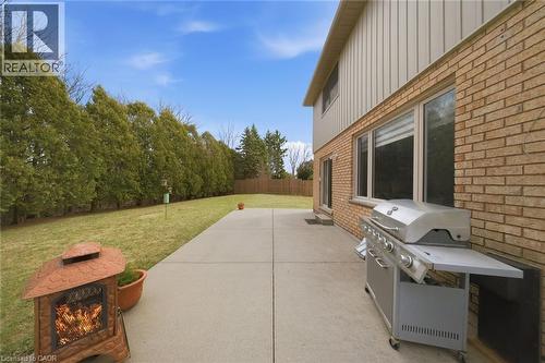 Expansive concrete patio with brick and siding exterior - 200 Morrison Drive, Caledonia, ON - Outdoor With Exterior