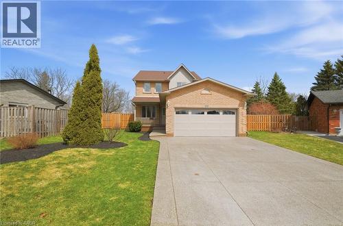 Brick-clad residence featuring a two-car garage, concrete driveway, and front porch - 200 Morrison Drive, Caledonia, ON - Outdoor