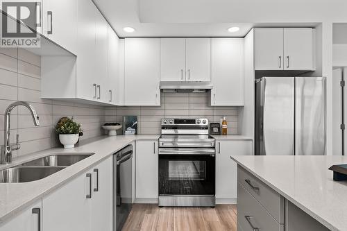 Kitchen. Photos may be of a similar home in the community. - 1111 Frost Road Unit# 202, Kelowna, BC - Indoor Photo Showing Kitchen With Stainless Steel Kitchen With Double Sink With Upgraded Kitchen