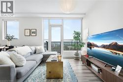 Living area featuring light wood-finish flooring and a white color palette - 