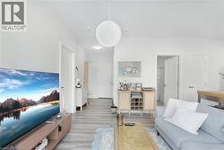 Bright interior with light wood-finish flooring and white walls - 