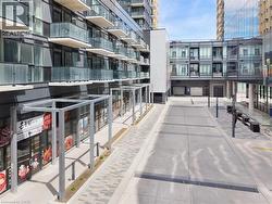 Modern high-rise exterior featuring a series of private balconies with glass railings - 