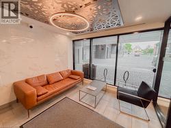 Modern lobby space featuring a decorative ceiling panel with integrated circular lighting - 