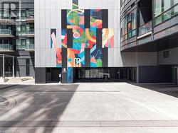 Modern building facade featuring a vibrant, multi-colored mural - 