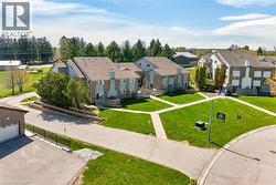 Townhouse-style buildings featuring brick and siding exteriors, gabled roofs, and chimney details - 