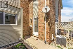 Exterior facade featuring light-colored horizontal siding and brickwork - 