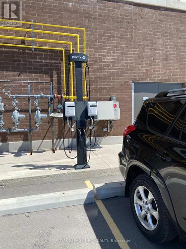 EV charging at designated parking space. - 604 - 118 West Street, Port Colborne (Sugarloaf), ON - Indoor Photo Showing Garage
