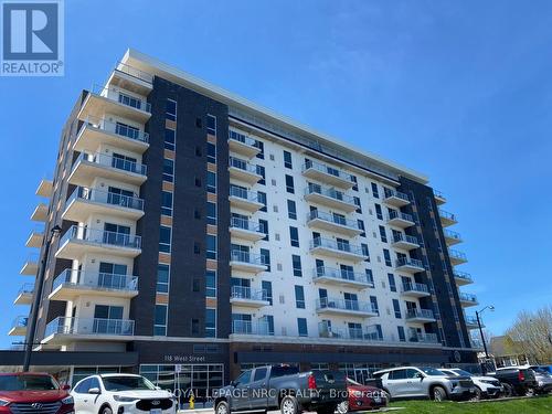 Front of building facing canal. - 604 - 118 West Street, Port Colborne (Sugarloaf), ON - Outdoor With Facade