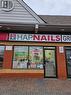 Commercial storefront featuring a brick facade with a horizontal accent band, a large display window, and a glass entry door - 9688 Leslie Street Unit# 16, Richmond Hill, ON 