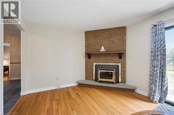 Brick-faced fireplace with a stone hearth and wood mantel - 
