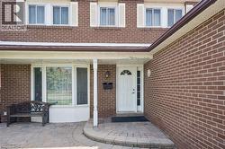 Brick exterior with white accents and a covered entryway - 