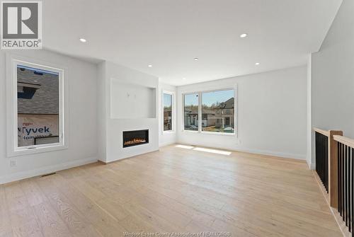 8312 Annie, Mcgregor, ON - Indoor Photo Showing Living Room With Fireplace
