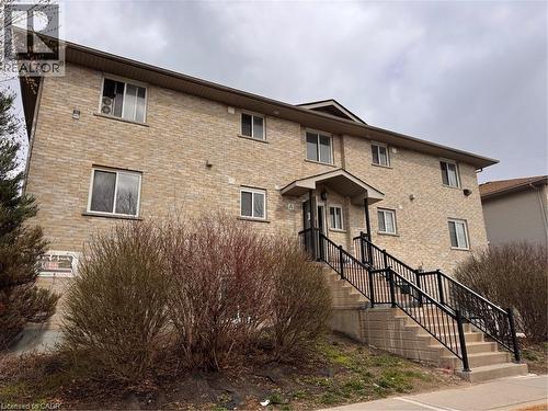 Two-story brick exterior building with multiple windows - 44 Walnut Street Unit# E01, Kitchener, ON - Outdoor With Exterior