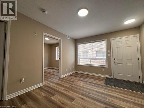 Entry area featuring wood-finish flooring, recessed lighting, and a white paneled front door - 44 Walnut Street Unit# E01, Kitchener, ON - Indoor Photo Showing Other Room