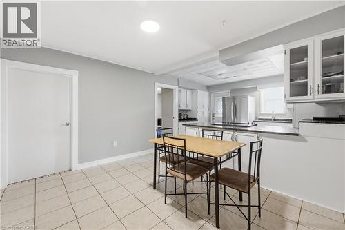 Kitchen area featuring white cabinetry, a granite-finish countertop, and stainless steel appliances - 2934 Baker Road, Niagara Falls, ON - Indoor