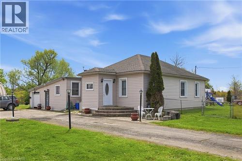 Exterior featuring light-colored siding, a dark roof, and a front entry with stone steps - 2934 Baker Road, Niagara Falls, ON - Outdoor