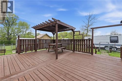 Expansive wooden deck featuring a built-in pergola, privacy fencing, and a permanent picnic table - 2934 Baker Road, Niagara Falls, ON - Outdoor With Deck Patio Veranda With Exterior
