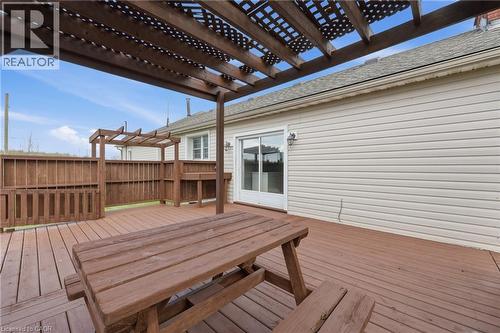 Expansive wood deck featuring a lattice pergola, privacy fencing, built-in counter space, and direct access to the interior via a sliding glass door - 2934 Baker Road, Niagara Falls, ON - Outdoor With Deck Patio Veranda With Exterior