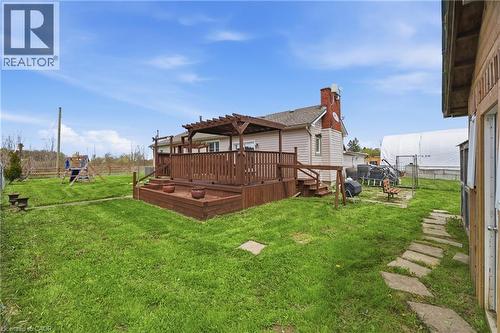 Expansive backyard featuring a multi-level wood deck with a pergola, a stone pathway, and open green space - 2934 Baker Road, Niagara Falls, ON - Outdoor