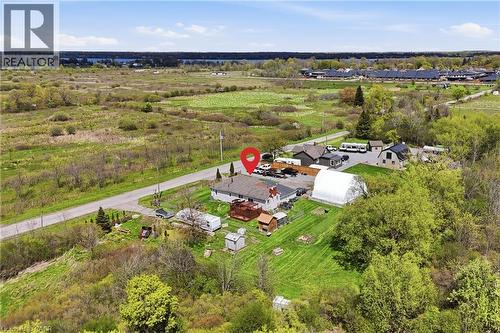 Aerial perspective showcasing a property with a residential structure, extensive green space, and a large white arched structure - 2934 Baker Road, Niagara Falls, ON - Outdoor With View