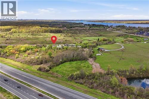 Expansive land parcel with highway frontage, green fields, and distant water bodies - 2934 Baker Road, Niagara Falls, ON - Outdoor With View