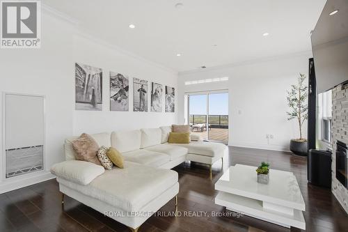 Upper: Bright Living Room - 1403 - 240 Villagewalk Boulevard, London North (North R), ON - Indoor Photo Showing Living Room With Fireplace