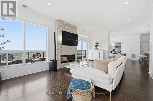 Upper: Open Concept Kitchen/Dining/Living Room - 1403 - 240 Villagewalk Boulevard, London North (North R), ON - Indoor Photo Showing Living Room With Fireplace