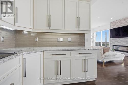 Upper: Kitchen with Hard Surface Counter Tops - 1403 - 240 Villagewalk Boulevard, London North (North R), ON - Indoor Photo Showing Kitchen With Upgraded Kitchen