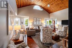 Living room - soaring ceilings, hardwood flooring - 