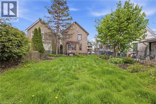 Expansive green space featuring mature trees and a chain-link fence border - 54 Evan Street, Welland, ON - Outdoor