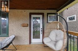 Front porch featuring a wood-finish floor and textured exterior siding - 