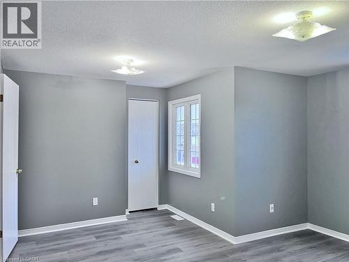 Room with gray walls, wood-finish flooring, and white trim - 193 Prosperity Drive, Kitchener, ON - Indoor Photo Showing Other Room