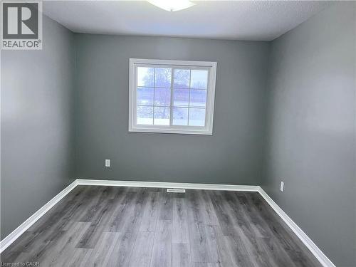 Room with gray walls, white trim, and wood-finish flooring - 193 Prosperity Drive, Kitchener, ON - Indoor Photo Showing Other Room
