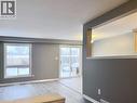 Living area featuring wood-finish flooring, a large window, and a sliding glass door providing exterior access - 193 Prosperity Drive, Kitchener, ON  - Indoor Photo Showing Other Room 