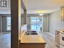 Kitchen area featuring a double basin stainless steel sink, light-toned countertops, and wood-finish cabinetry - 193 Prosperity Drive, Kitchener, ON  - Indoor Photo Showing Kitchen With Double Sink 
