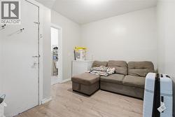 Light wood-finish flooring complements the neutral wall color - 
