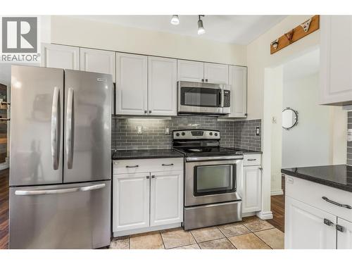 Tons of cupboards - 1385 Orchard Drive, Kelowna, BC - Indoor Photo Showing Living Room