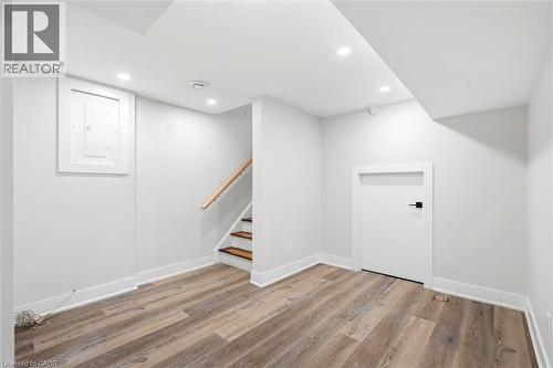 Finished lower level featuring wood-finish flooring, recessed lighting, and white baseboards - 16 Ronaldshay Avenue, Hamilton, ON - Indoor Photo Showing Other Room