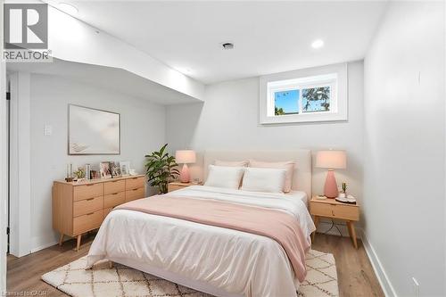 Bright bedroom featuring light wood-finish flooring and recessed lighting - 16 Ronaldshay Avenue, Hamilton, ON - Indoor Photo Showing Bedroom