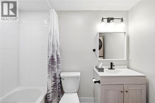 Bathroom featuring a white bathtub, toilet, and a vanity with a white countertop - 16 Ronaldshay Avenue, Hamilton, ON - Indoor Photo Showing Bathroom