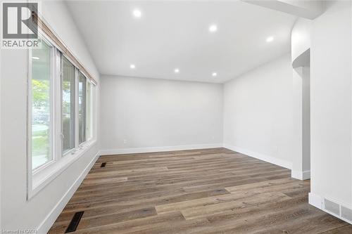 Spacious room featuring wood-finish flooring, white baseboards, and recessed lighting - 16 Ronaldshay Avenue, Hamilton, ON - Indoor Photo Showing Other Room