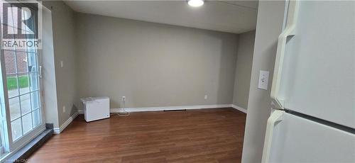 Room featuring wood-finish flooring, neutral wall tones, and white baseboards - 274 E Highland Road E Unit# 10, Kitchener, ON - Indoor Photo Showing Other Room