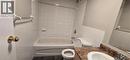 Full bathroom featuring a white bathtub/shower combination with tile surround, a white toilet, and a vanity with a white sink and a brown speckled countertop - 274 E Highland Road E Unit# 10, Kitchener, ON  - Indoor Photo Showing Bathroom 